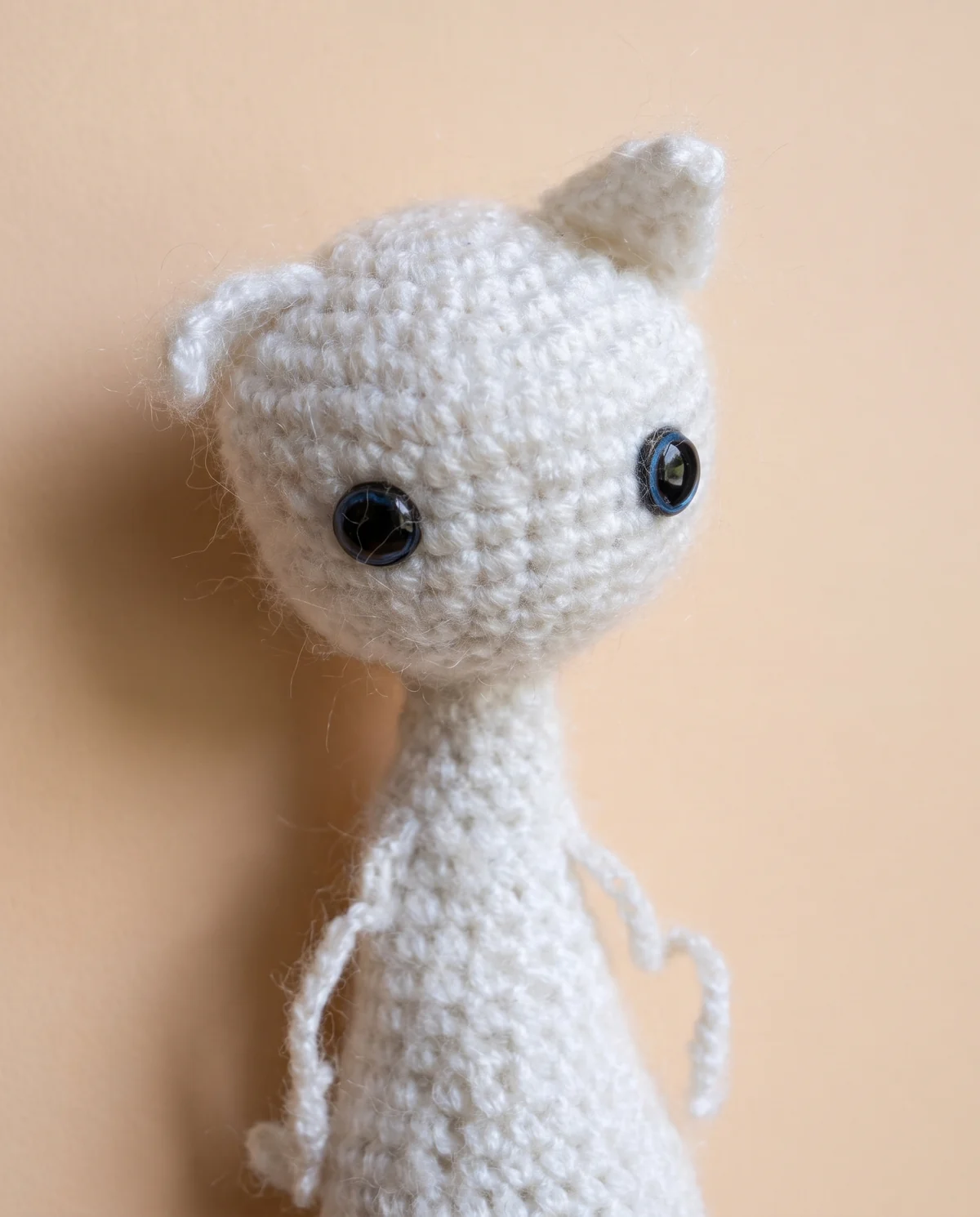 Artistic close-up of Floppy-Cat's face and yarn texture